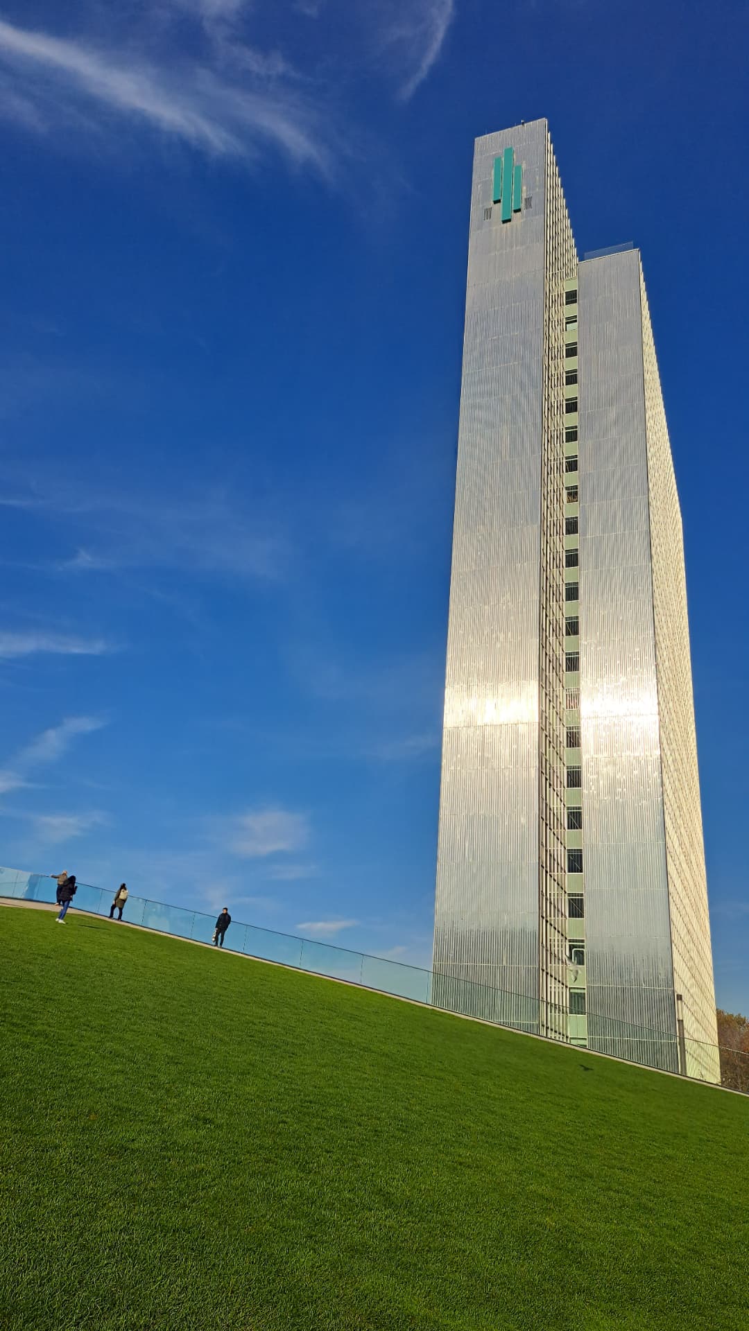 A tall glass tower against a blue sky
